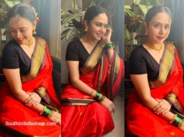 amruta khanvilkar in red traditional saree