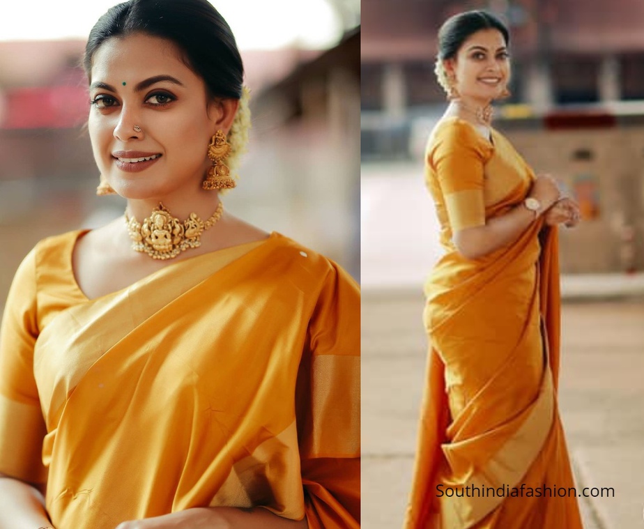 Actress Anusree in a golden orange pattu saree in guruvayur