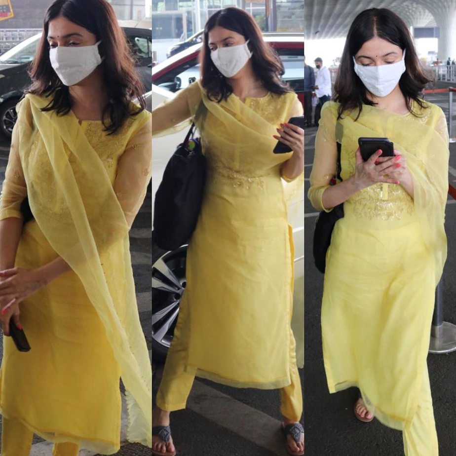 divya khosla kumar wearing a yellow outfit at airport