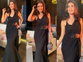 karishma tanna in a black pre-draped saree