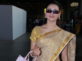 urvashi rautela in a checkered brown saree at airport