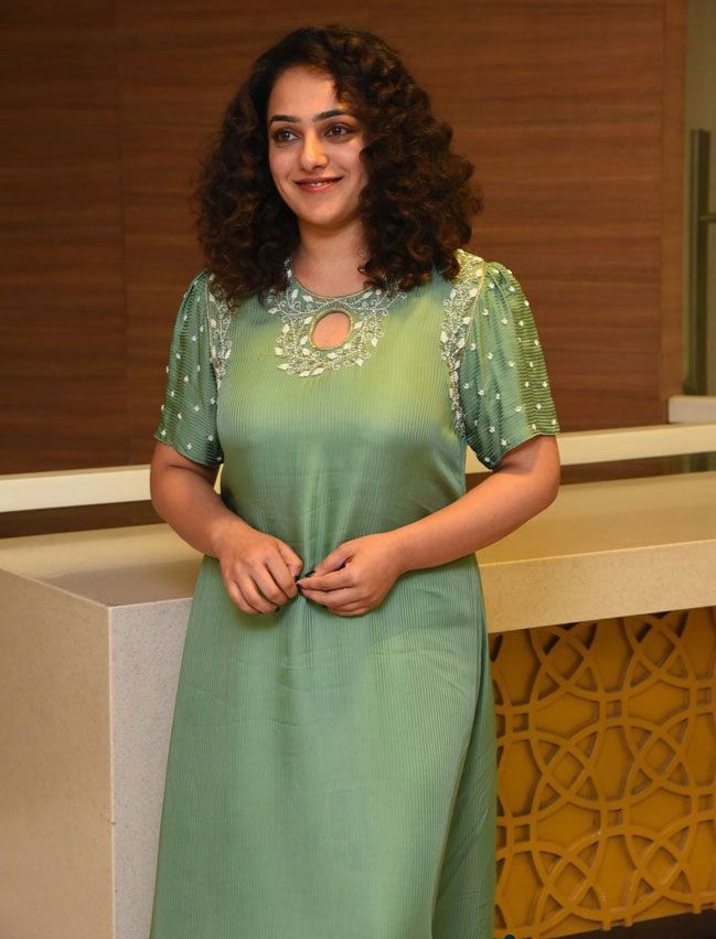 nithya menen in a green asymmetrical kurta at movie interview