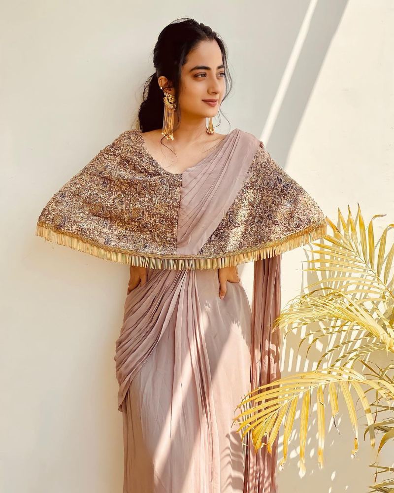 namitha pramod in a beige saree gown with cape