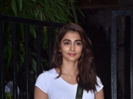 Pooja Hegde in side slit yellow pants and white crop top at Rohan Shresta's office