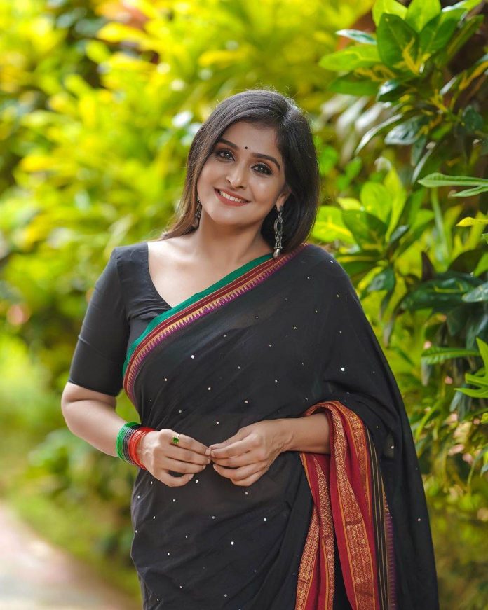 Ramya Nambessan's traditional look in a black mirror work saree!