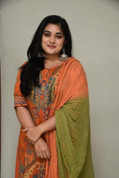 Nivetha Thomas'graceful look in an orange sharara suit for 